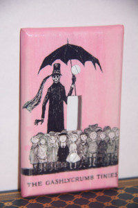 The Gashlycrumb Tinies Switch Plate ~ Gashlycrumb Tinies illustration by Edward Gorey with faded pink background. Graphic configuration created by creator Alana C (which I am guessing stands for "Crafty") on Photoshop. See this, and other creations, on the SpunkKnit shop...... again, on Etsy!