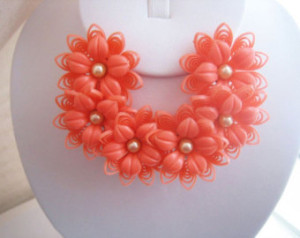 Fun, chunky, flowery vintage costume jewelry! Rather it be necklaces, bracelets, or earrings (like these charmingly cheery clip on earrings!)...... get funky & daring with your accessories this season! There is NO other season as playful and spring - everything is just coming out of their lairs, pollination is in the air, and brightly beautiful things are beginning to burgeon up from the supple earth beneath your newly painted feet...... live a little! And you don't have to spend a bundle because plastic is perfectly acceptable always, but more than anything right now when it's *time* to be playful. ;)